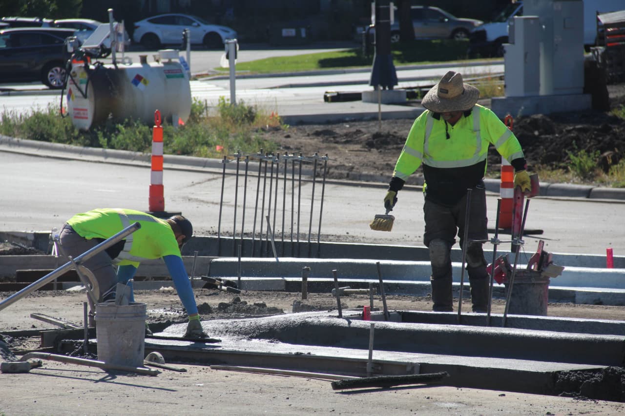 Two construction workers at a work site.