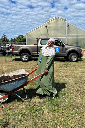 Young woman happily pushing wheelbarrow