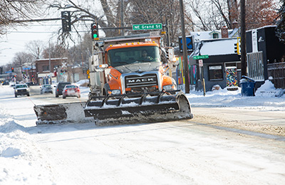 Single plow truck on county road in city