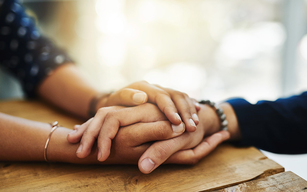 Close up of two people holding hands