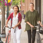 Two women walking a bike in Robbinsdale. 
