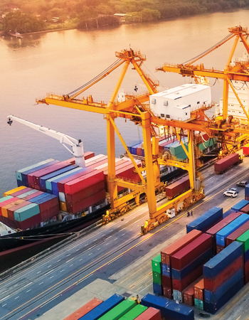 cargo ship being unloaded along river