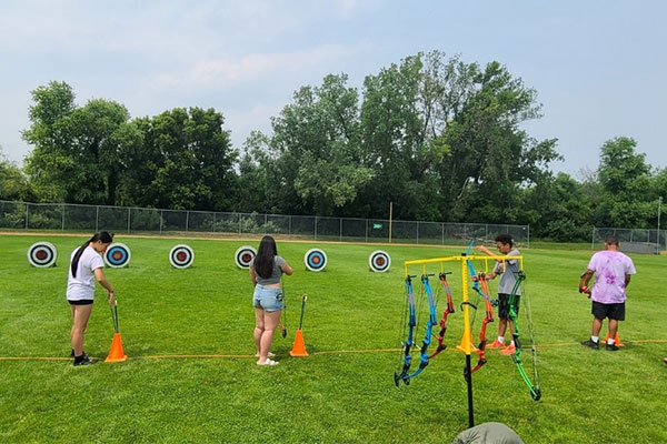 kids doing archery outside