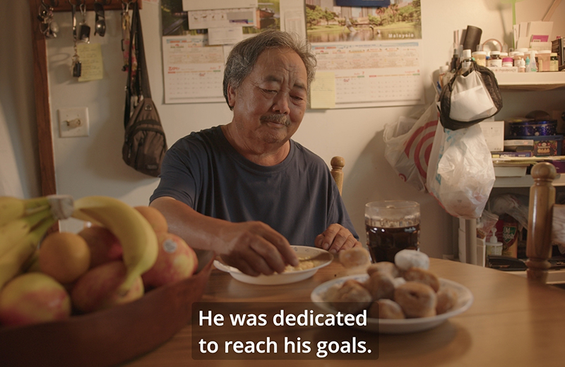man eating at table with words He was dedicated to reach his goals.
