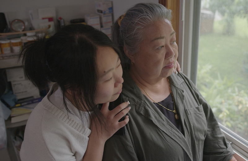 mother and daughter looking out the window