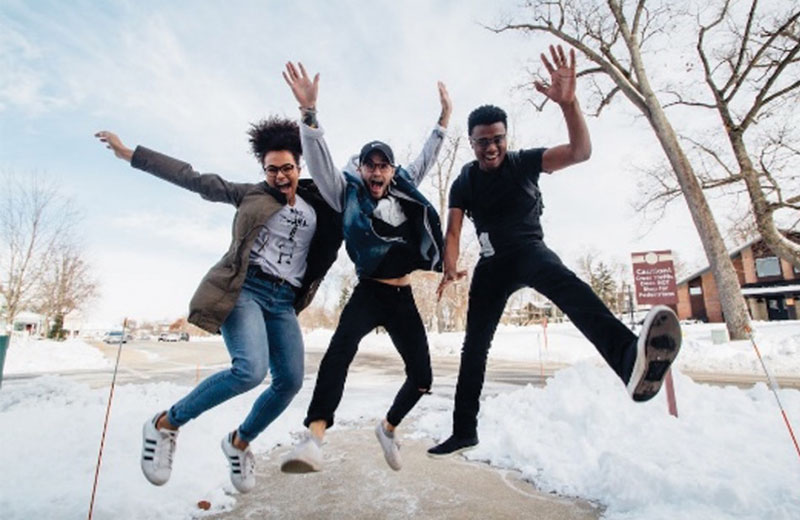 people jumping in the snow